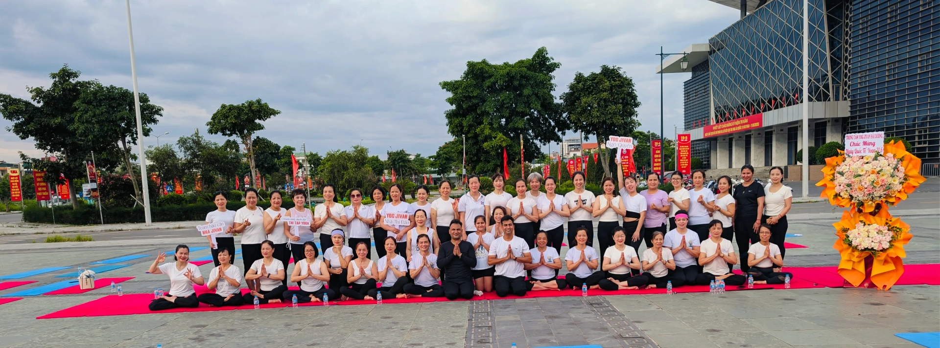 International Yog Jivan community seated in namaste at the studio