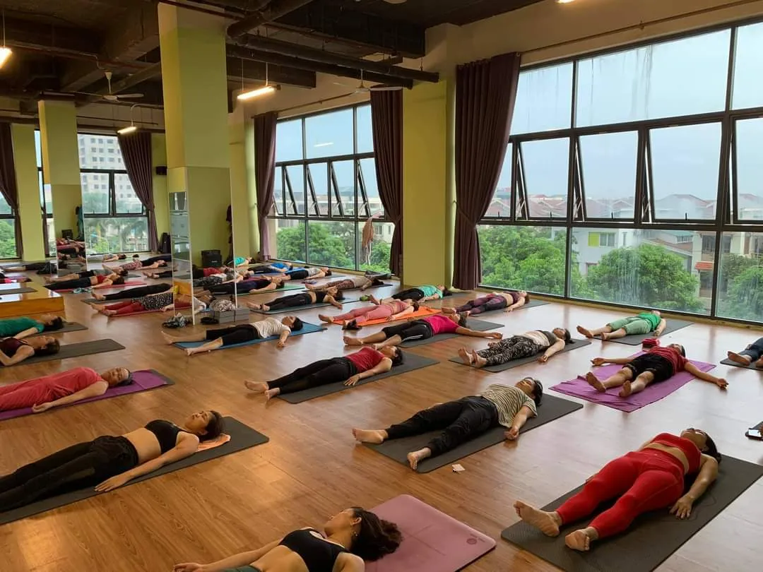 Students resting deeply in Savasana at the close of a stress-relief class