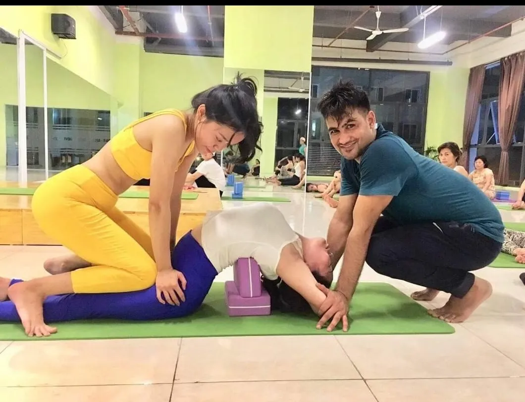 Master Anil giving a therapeutic hands-on adjustment for lower-back alignment